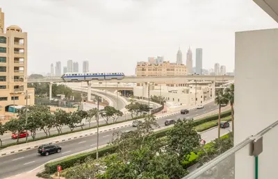 a view of a city with a train crossing a highway at New Arabian Five Palm Residences in Dubai