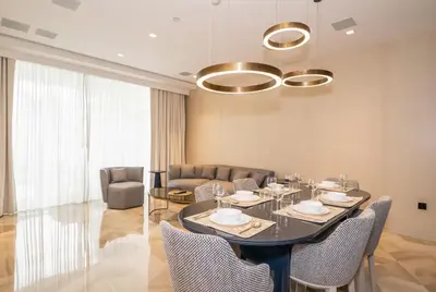 a dining room with a table and chairs at New Arabian Five Palm Residences in Dubai