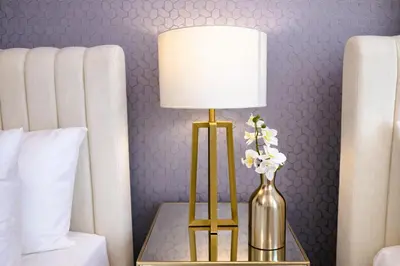 a lamp on a table with a vase of flowers at Elite Royal Apartment - Sky Series - Highest Apartment Floor - Full Burj Khalifa & New Fountain View - Eternal in Dubai