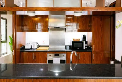 a kitchen with wooden cabinets and a counter top at Elite Royal Apartment - Sky Series - Highest Apartment Floor - Full Burj Khalifa & New Fountain View - Eternal in Dubai