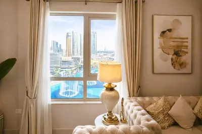 a living room with a couch and a large window at Elite Royal Apartment - Sky Series - Highest Apartment Floor - Full Burj Khalifa & New Fountain View - Eternal in Dubai