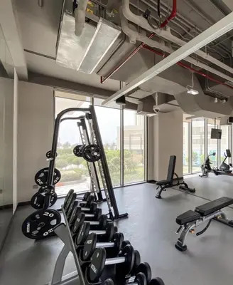 a gym with several tread machines in a room at Creek Harbour Home Burj Khalifa Downtown View in Dubai