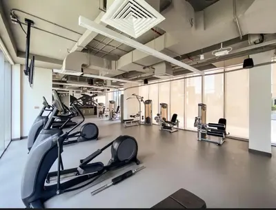 a gym with treadmills and elliptical machines at Creek Harbour Home Burj Khalifa Downtown View in Dubai