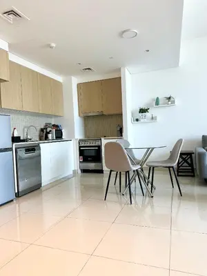 a kitchen with white appliances and a table and chairs at Creek Harbour Home Burj Khalifa Downtown View in Dubai