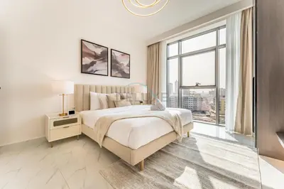 a white bedroom with a bed and a large window at Perfectly Positioned Near Dubai Miracle Garden and Butterfly Garden, Quick Drive to Global Village, Adhara Star, Arjan by Deluxe Holiday Homes in Dubai