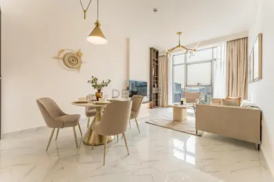 a dining room and living room with a table and chairs at Perfectly Positioned Near Dubai Miracle Garden and Butterfly Garden, Quick Drive to Global Village, Adhara Star, Arjan by Deluxe Holiday Homes in Dubai