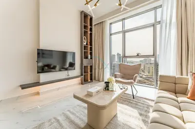 a living room with a couch and a tv at Perfectly Positioned Near Dubai Miracle Garden and Butterfly Garden, Quick Drive to Global Village, Adhara Star, Arjan by Deluxe Holiday Homes in Dubai