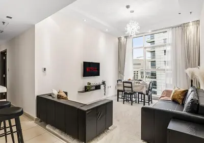 a living room with a couch and a table at Two Bedroom Apartment at JBR with Marina and Bluewaters Views in Dubai