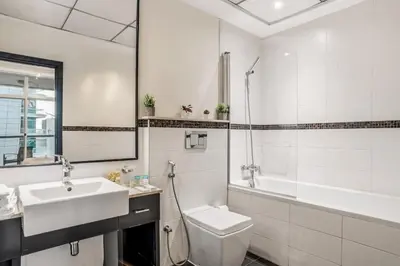 a bathroom with a sink and a toilet and a tub at Two Bedroom Apartment at JBR with Marina and Bluewaters Views in Dubai