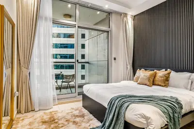 a bedroom with a large bed and a large window at Two Bedroom Apartment at JBR with Marina and Bluewaters Views in Dubai