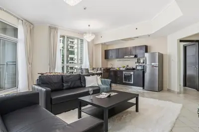 a living room with a couch and a table at Stylish Large 2BR Apartment in the Heart of Dubai Marina in Dubai