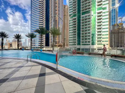 a swimming pool in a city with tall buildings at Stylish Large 2BR Apartment in the Heart of Dubai Marina in Dubai