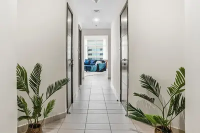 a hallway with potted plants in a house at Stylish Large 2BR Apartment in the Heart of Dubai Marina in Dubai