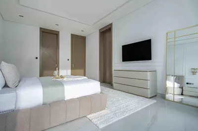 a bedroom with a large bed and a television at Frank Porter - Villa La Mer, Jumeirah 1 in Dubai