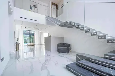 a living room with a staircase in a house at Frank Porter - Villa La Mer, Jumeirah 1 in Dubai
