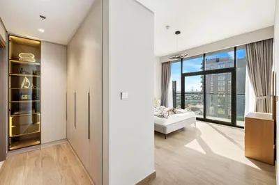 a living room with a couch and a large window at Brand New 1BR Apartment In Amalia Residences Al Furjan in Dubai