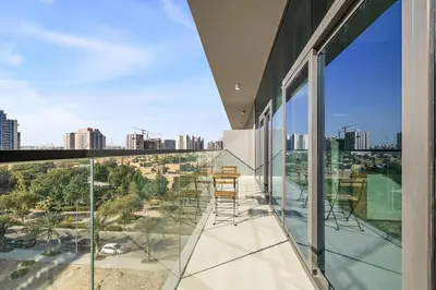 a balcony with chairs and a view of the city at Brand New 1BR Apartment In Amalia Residences Al Furjan in Dubai