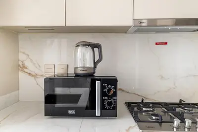 a blender sitting on top of a microwave at Brand New 1BR Apartment In Amalia Residences Al Furjan in Dubai