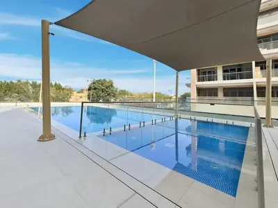 a swimming pool on the roof of a building at Brand New 1BR Apartment In Amalia Residences Al Furjan in Dubai