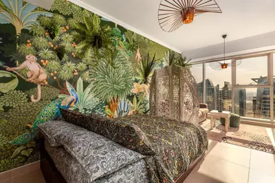 a bedroom with a mural of plants on the wall at Waves - Nature-Inspired Studio - JLT Skyline Living in Dubai