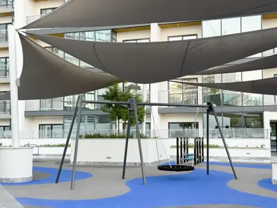 a swing set in front of a building at Stylish & Cozy Fully Furnished 2BR plus Maid Crest C in Dubai
