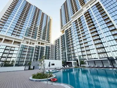 a swimming pool in front of two tall buildings at Stylish & Cozy Fully Furnished 2BR plus Maid Crest C in Dubai