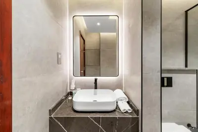 a bathroom with a sink and a mirror at 2BR Duplex DIFC Near Museum of the Future in Dubai
