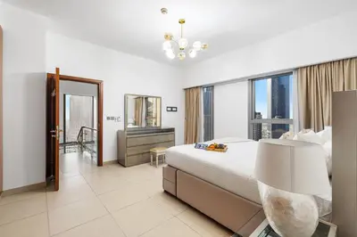 a hotel room with a bed and a large window at 2BR Duplex DIFC Near Museum of the Future in Dubai