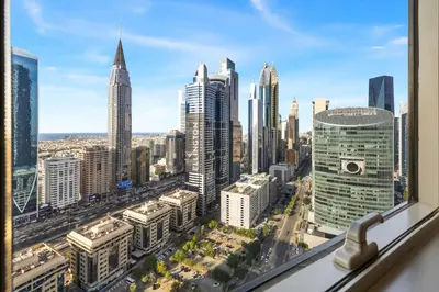 a view of a city skyline from a window at 2BR Duplex DIFC Near Museum of the Future in Dubai