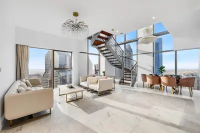 a living room with a spiral staircase in a building at 2BR Duplex DIFC Near Museum of the Future in Dubai