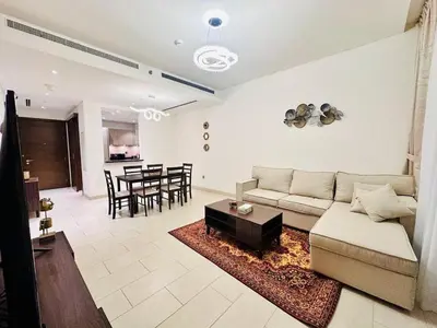 a living room with a couch and a table at Greens Community View Spacious 1BR Fully Furnished in Dubai