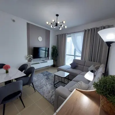 a living room with a couch and a tv at Modern 1BR Duplex Jumeirah Bay X1-1 In JLT in Dubai