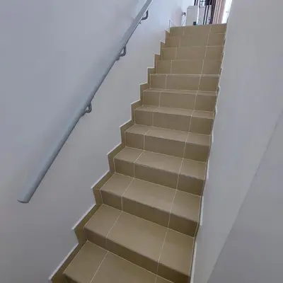 a stairway with brown tiles on the stairs at Modern 1BR Duplex Jumeirah Bay X1-1 In JLT in Dubai