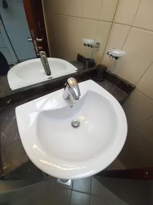 a white sink in a bathroom with a mirror at Modern 1BR Duplex Jumeirah Bay X1-1 In JLT in Dubai