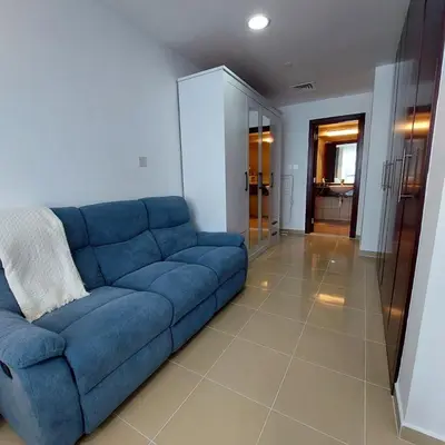 a blue couch sitting in a living room at Modern 1BR Duplex Jumeirah Bay X1-1 In JLT in Dubai