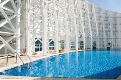 a large building with a large swimming pool at Modern 1BR Duplex Jumeirah Bay X1-1 In JLT in Dubai