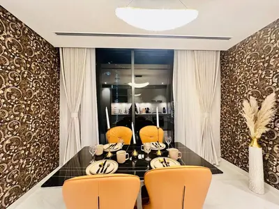 a dining room with a table and two chairs at Brand New 1BR in Creek Vista Grande in Dubai