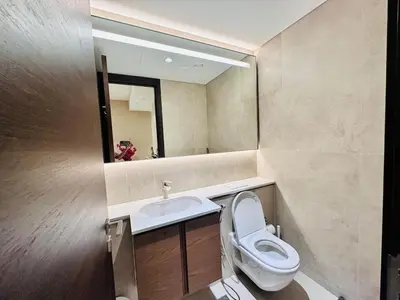 a bathroom with a toilet and a sink at Brand New 1BR in Creek Vista Grande in Dubai
