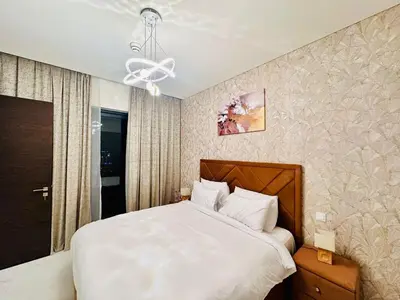 a bedroom with a bed and a ceiling fan at Brand New 1BR in Creek Vista Grande in Dubai