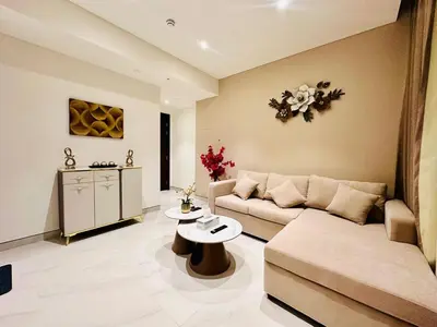 a living room with a couch and a table at Brand New 1BR in Creek Vista Grande in Dubai