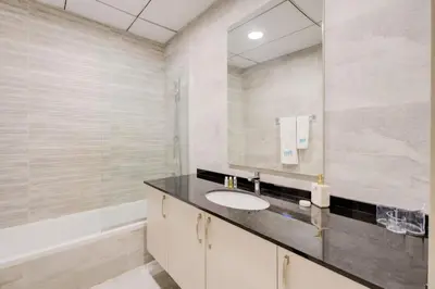 a bathroom with a sink and a mirror at Elegant 1BR in Polo Residences Nad Al Sheba in Dubai