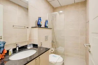 a bathroom with a sink and a toilet and a shower at Elegant 1BR in Polo Residences Nad Al Sheba in Dubai