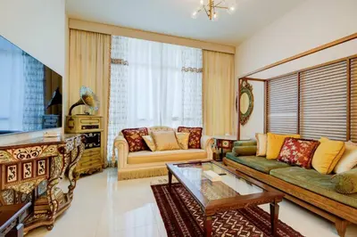 a living room with a couch and a coffee table at Elegant 1BR in Polo Residences Nad Al Sheba in Dubai