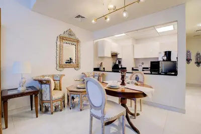 a kitchen and dining room with a table and chairs at Elegant 1BR in Polo Residences Nad Al Sheba in Dubai