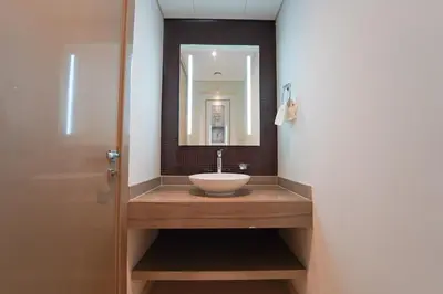 a bathroom with a sink and a mirror at Stylish 2BR Paramount Tower D in Dubai