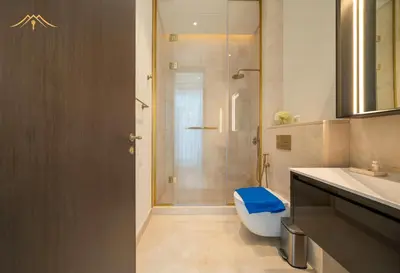 a bathroom with a shower with a toilet and a sink at New Arabian Palm Hills 6BR & Maid & Private Pool in Dubai