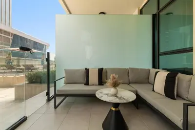 a living room with a couch and a table at Stylish Missoni Studio With Direct Pool Access in Dubai