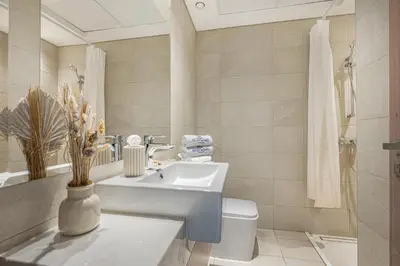a bathroom with a sink and a toilet at Bright & Stylish Home in the Heart of Meydan in Dubai