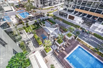 an overhead view of a building with a pool at Bright & Stylish Home in the Heart of Meydan in Dubai