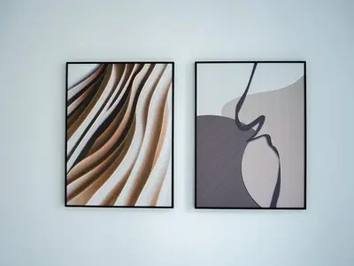two framed illustrations of a painting of a woman at Marina Beachfront Oasis Infinity Pool & Modern Comfort in Dubai